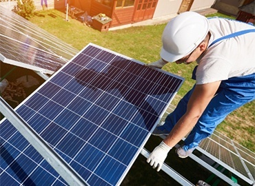 man worker firld by solar panels